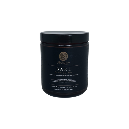 An amber jar with a black lid and black label of Alchemy Body Werks Bare Body Butter on a white background.
