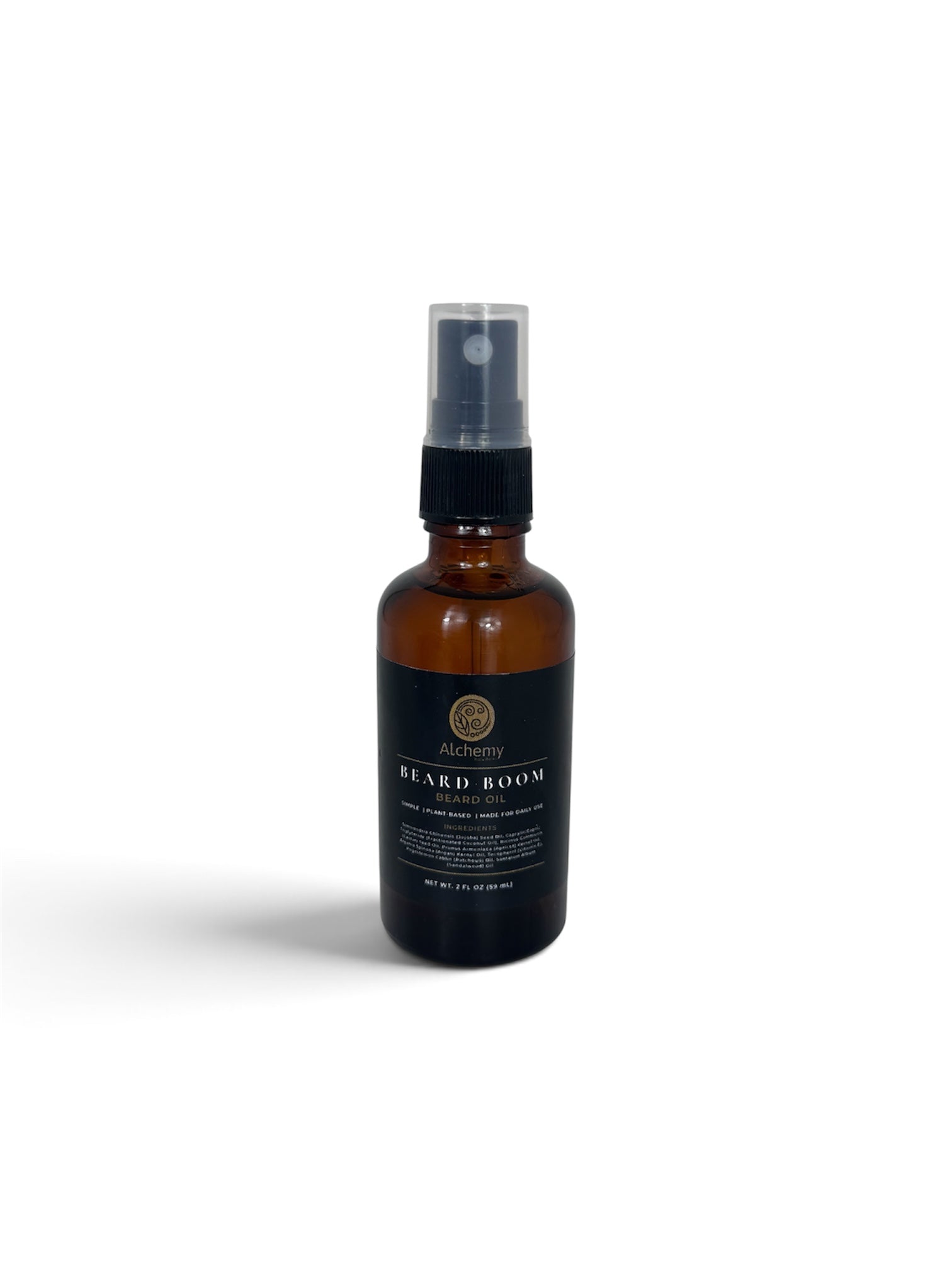 An amber glass bottle spray bottle with a black spray top and a black label of Alchemy Body Werks Beard Boom Beard Oil on a soft white background.