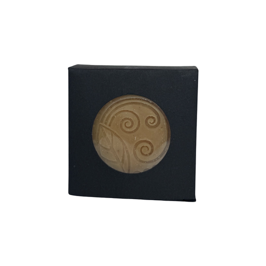 Alchemy Body Werks Gold soap bar in a matte black box on a white background.