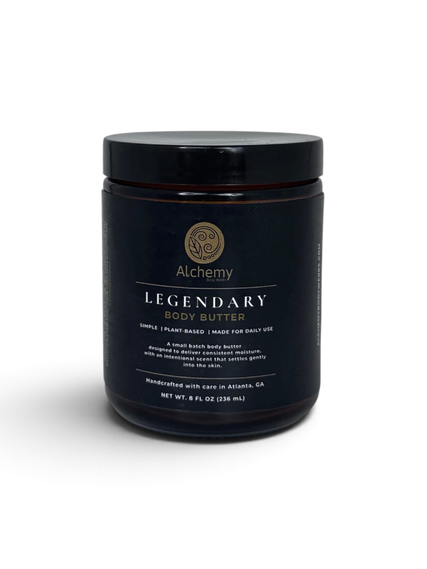An amber jar with black lid and black label of Alchemy Body Werks Legendary Body Butter on a white background with a soft shadow.