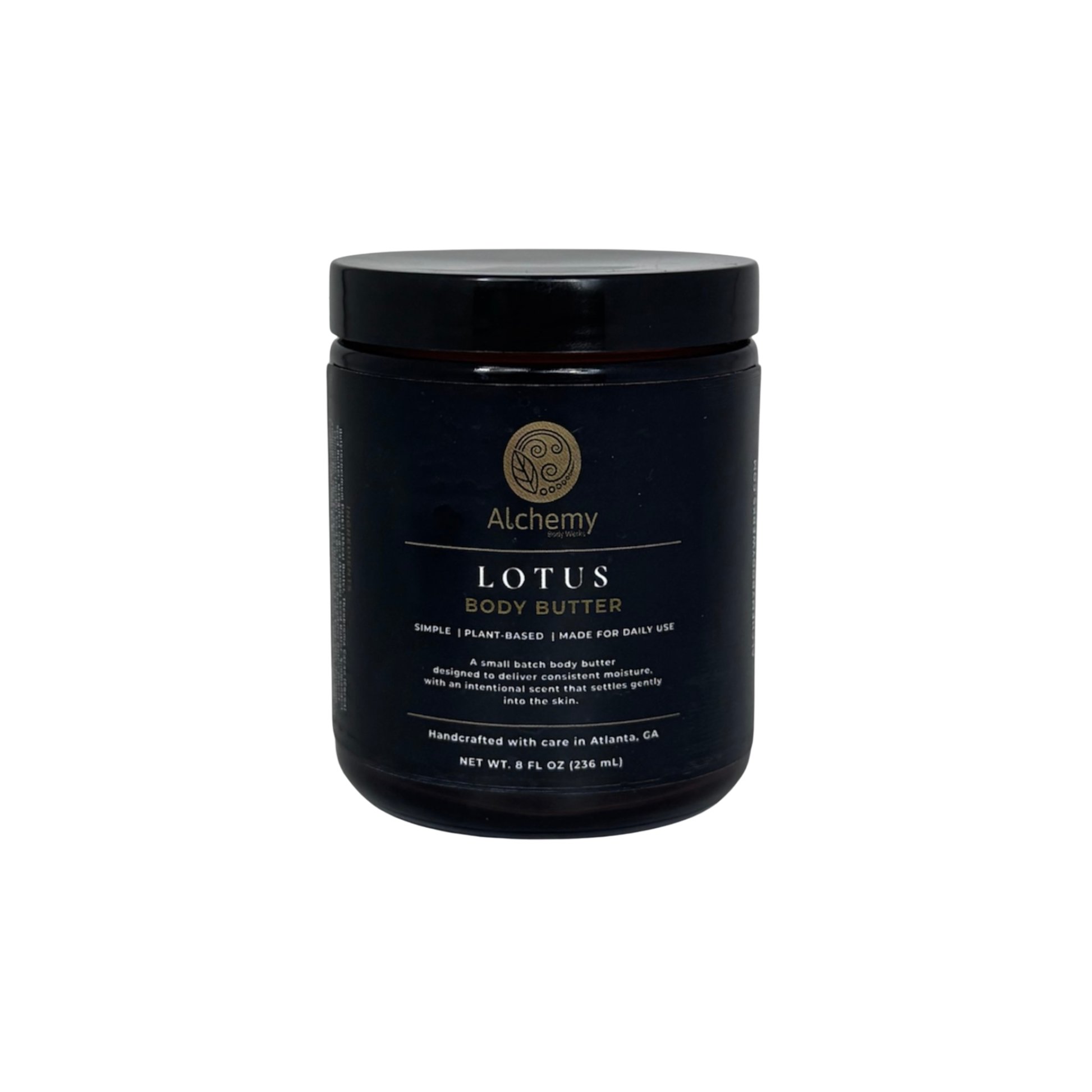 An amber jar with black lid and black label of Alchemy Body Werks Lotus Body Butter on a white background.