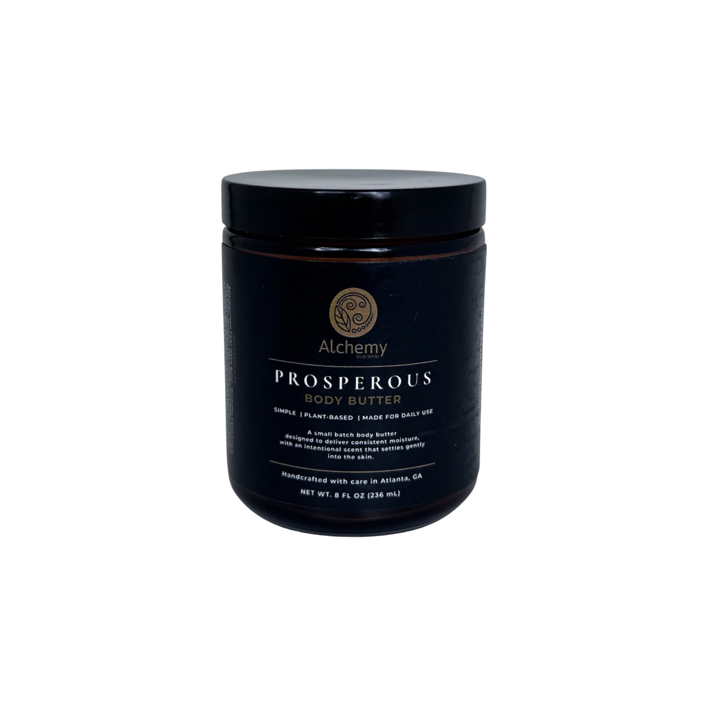 An amber jar with a black lid and black label of Alchemy Body Werks Prosperous Body Butter on a white background.