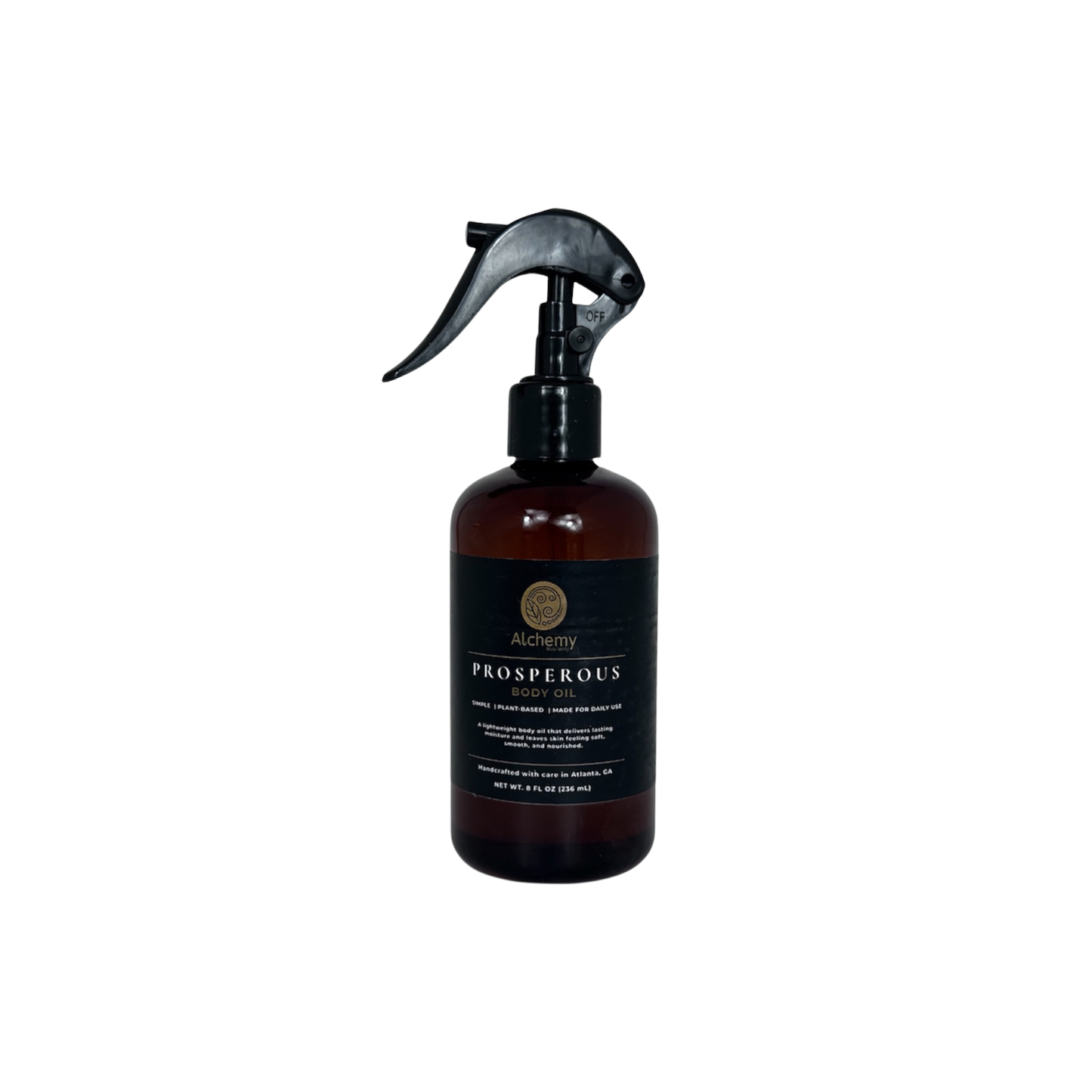 An amber spray bottle with a black trigger sprayer and a black label of Alchemy body Werks Prosperous Body Oil on a clean white background.